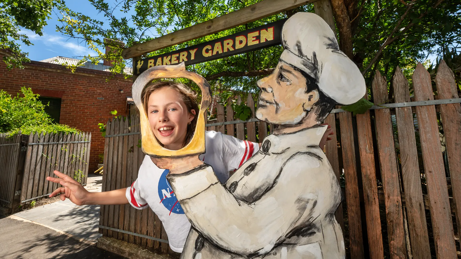 Alannah Bell: having a laugh in a loaf at the newly accessible bakery garden. Photo courtesy Rob Leeson.