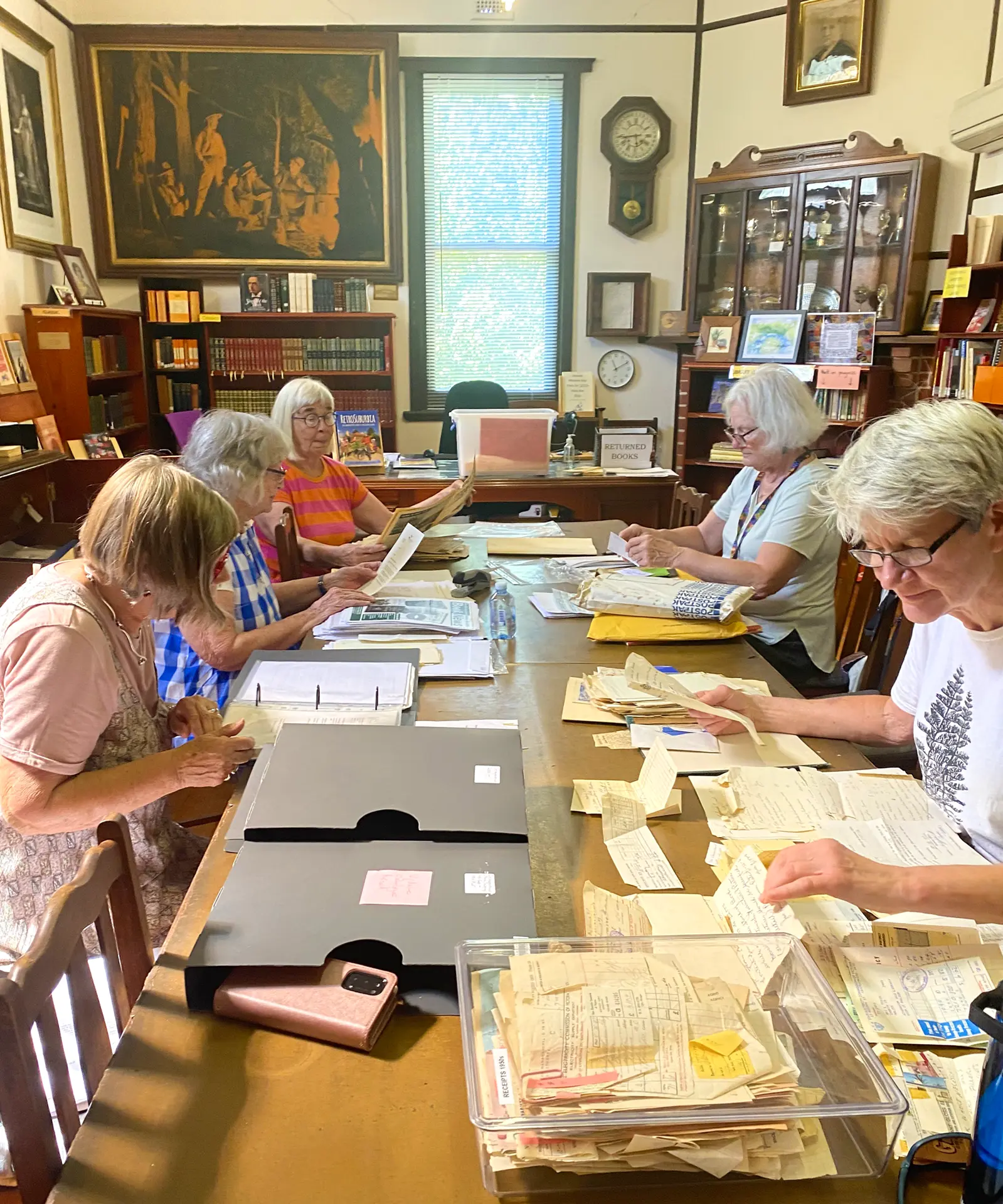 Volunteers working on the library’s archives.