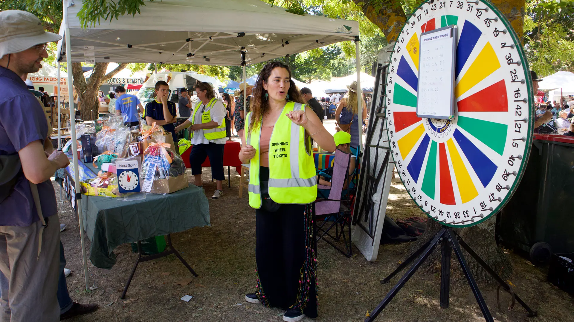 Rakaia (foreground) and Nicole (background) managing the spinning Wheel and prizes.