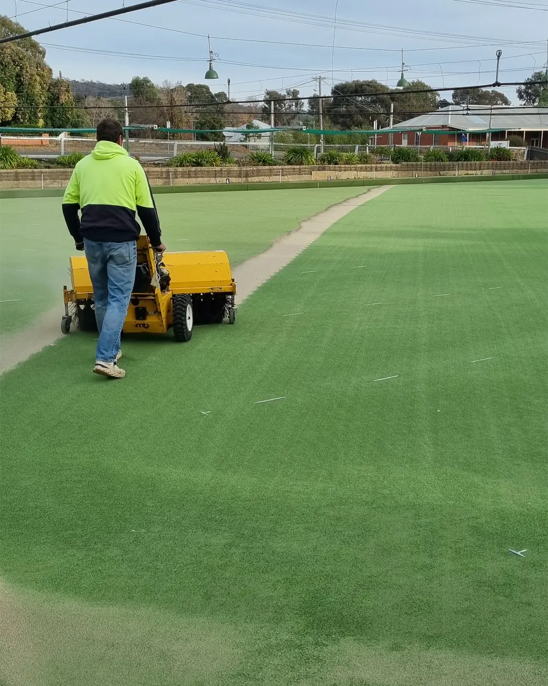 Brushing the green.